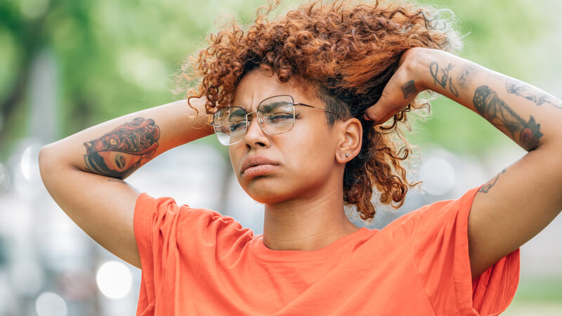 Woman pulling hair up off neck