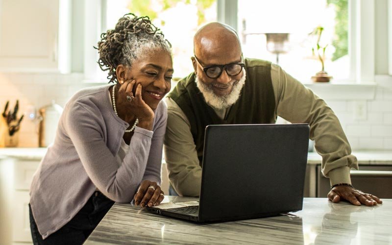 Man and woman taking a health risk assessment on a laptop