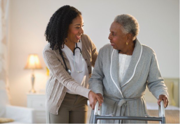 Medical professional walking patient through rehab