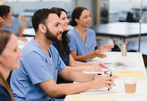 People in medical scrubs attending a lecture